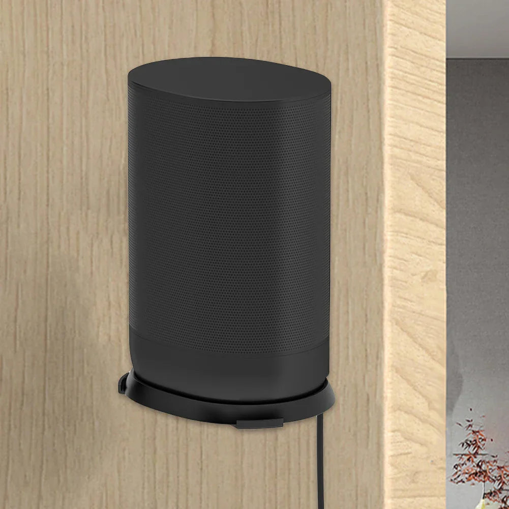 Black cylindrical speaker on a wall stand holder shelf made of aluminum alloy for space saving and mounting use