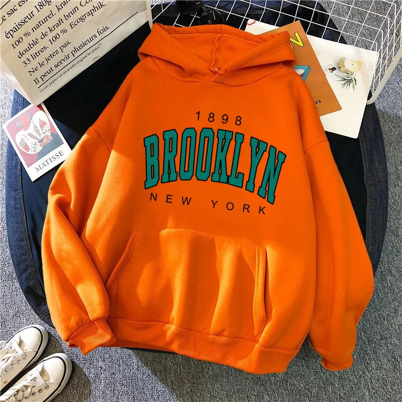 Vibrant orange fleece loose women’s hoodie with bold green and black brooklyn new york lettering hot selling couple hoodie sweatshirt