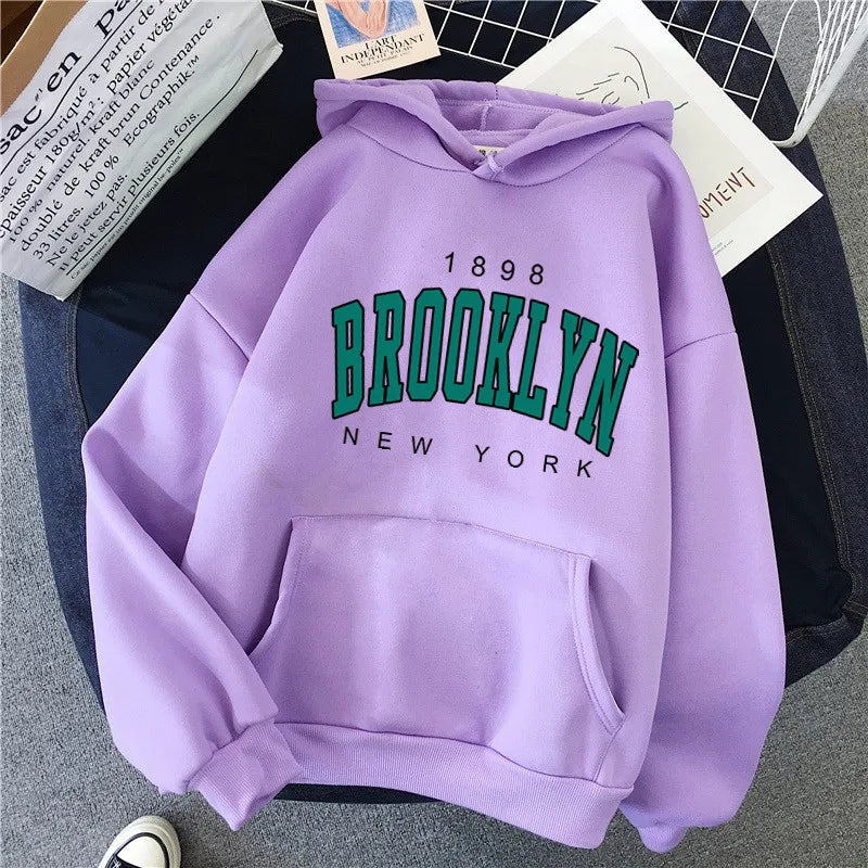 A soft lavender fleece hoodie hot selling with bold green brooklyn new york lettering and front pocket for couples