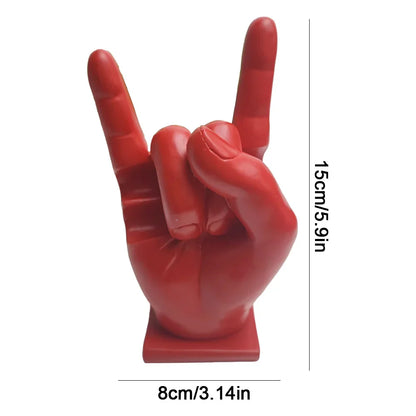 Red glossy resin hand sculpture making rock gesture used as modern drum stick holder and display stand for home decor