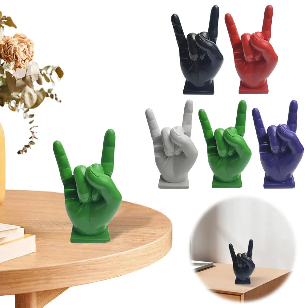 Vibrant green resin hand sculpture in rock gesture used as a drum stick holder and display stand on wooden table