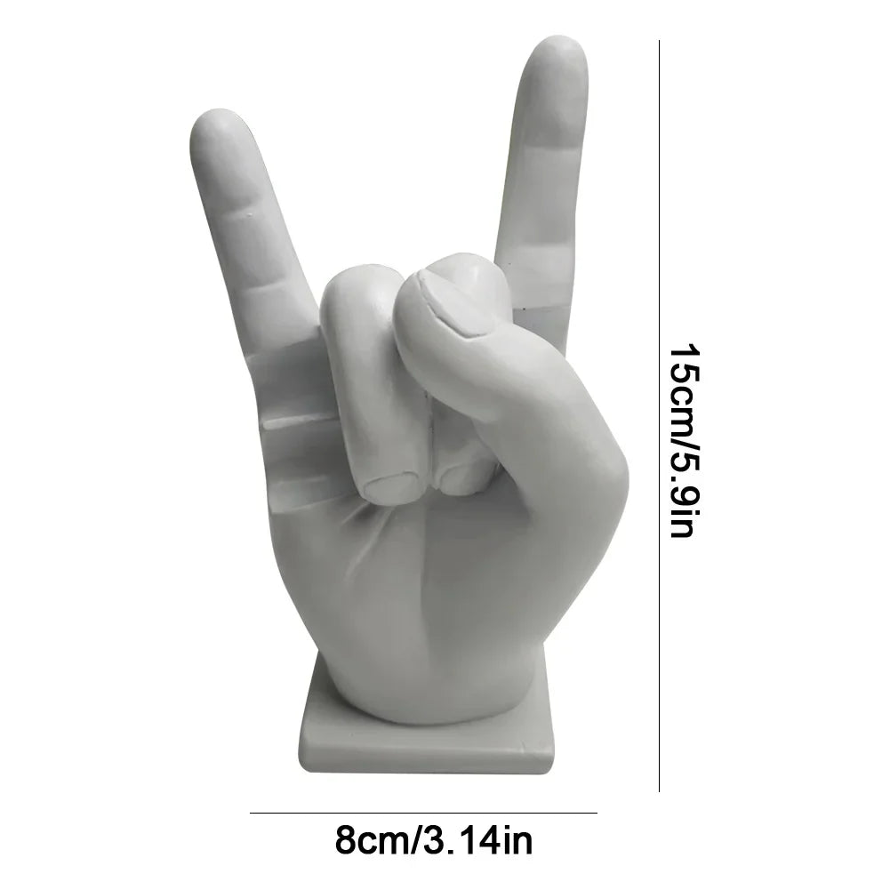 White resin statue of a hand making the rock on sign used as a modern drum stick holder and display stand for home decor