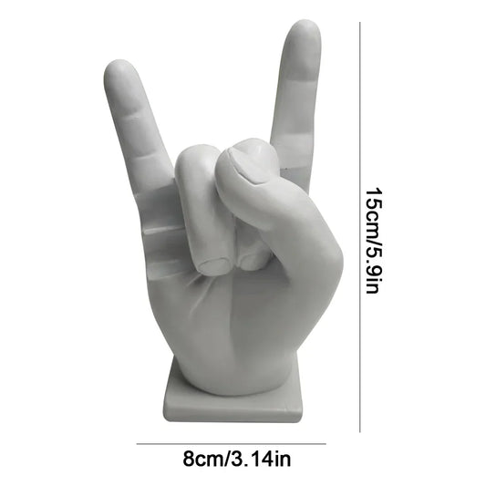 White resin statue of a hand making the rock on sign used as a modern drum stick holder and display stand for home decor