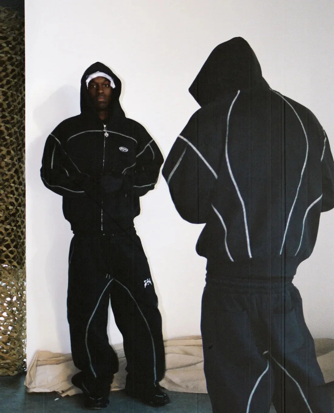 Black hooded tracksuit with white piping and small chest logo featuring trendy silhouettes unique for casual hoodies