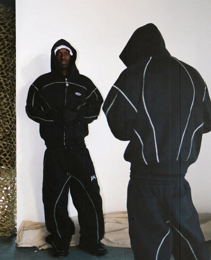 Black hooded tracksuit with white piping and small chest logo featuring trendy silhouettes unique for casual hoodies