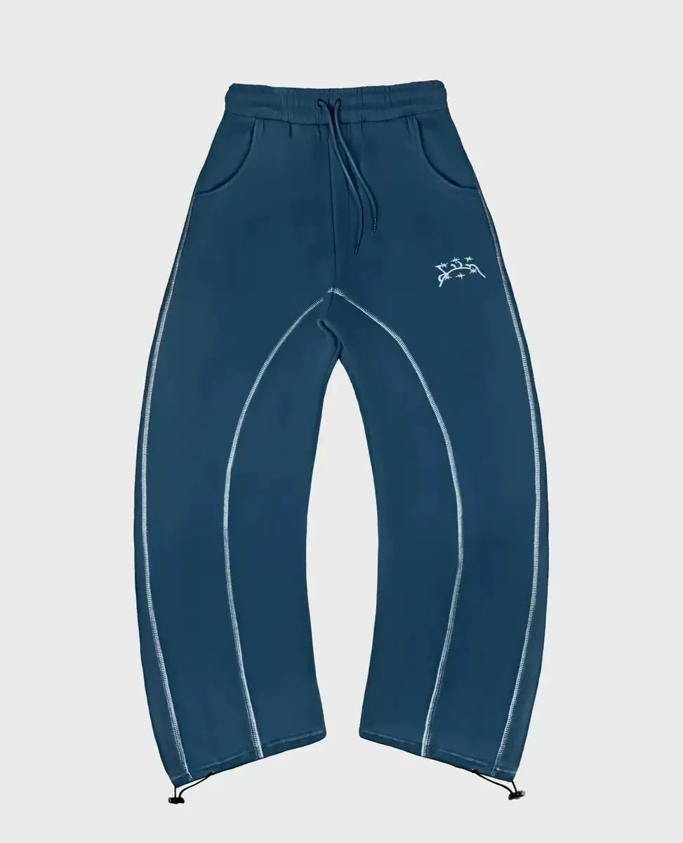 Dark teal sweatpants with light blue contrast stitching and white logo complement patterned oversized sweatshirts casual hoodies