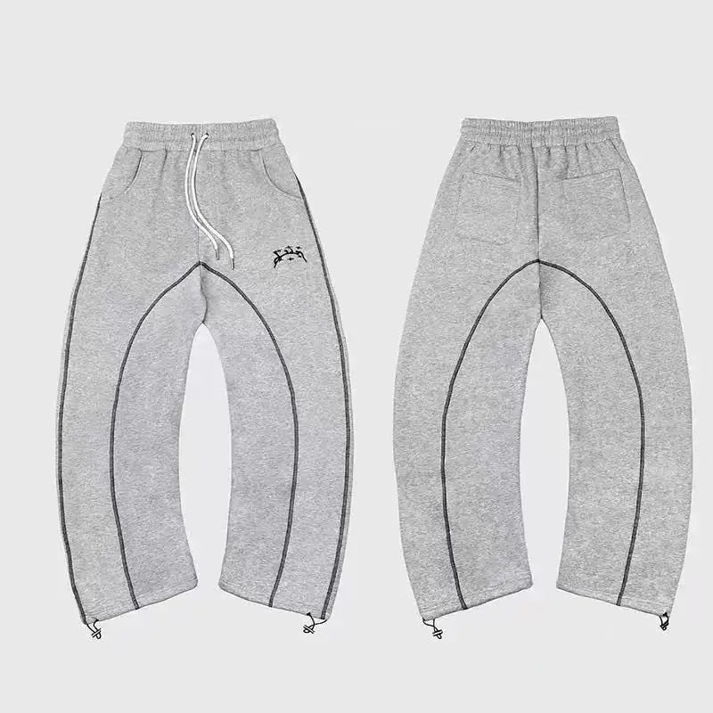 Gray heathered sweatpants with black contrast stitching and embroidered logo paired with patterned oversized sweatshirts casual hoodies