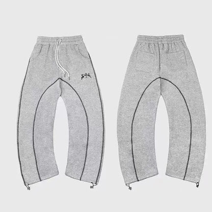 Gray heathered sweatpants with black contrast stitching and embroidered logo paired with patterned oversized sweatshirts casual hoodies