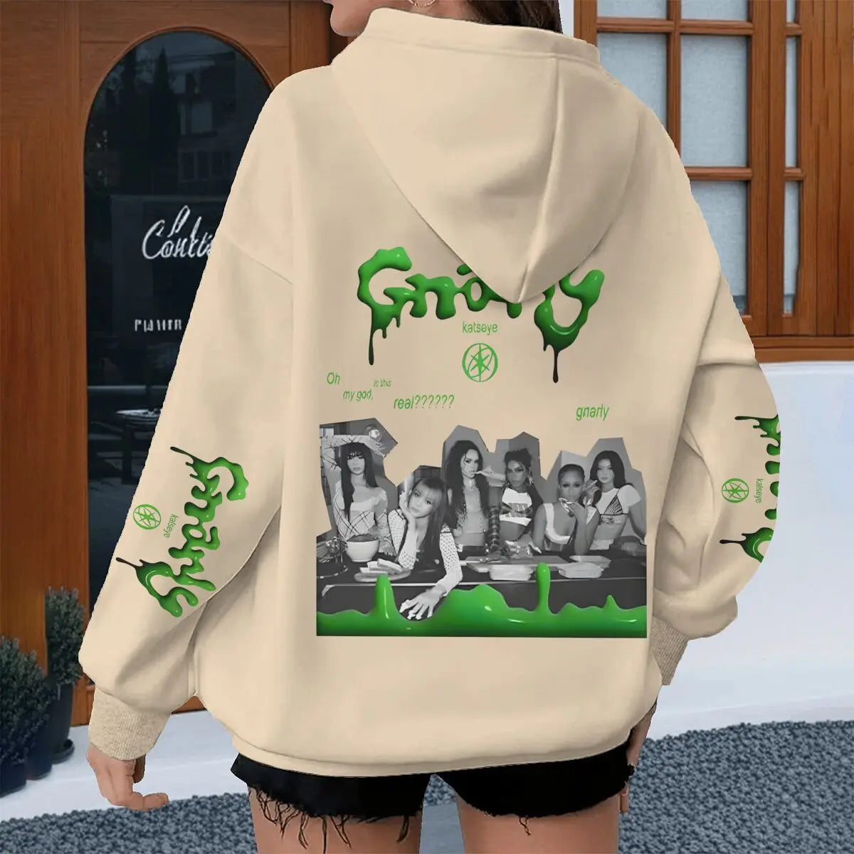 Back of cream-colored street style katseye hoodie with green grainy paint graphic and black and white band katseye streetwear photo printed