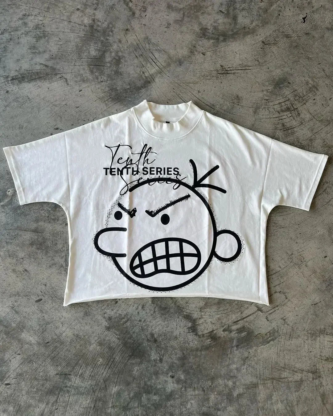 White cropped cotton t-shirt with black spray-painted cartoon face and tenth series text for shirt y2k clothing and streetwear boy scout style