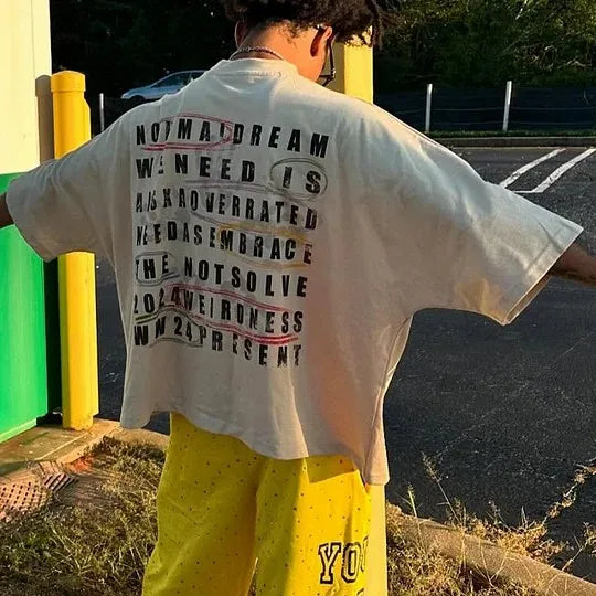 Back of a white cotton oversized shirt y2k clothing with bold black text red underlines and streetwear boy scout gothic hip hop style