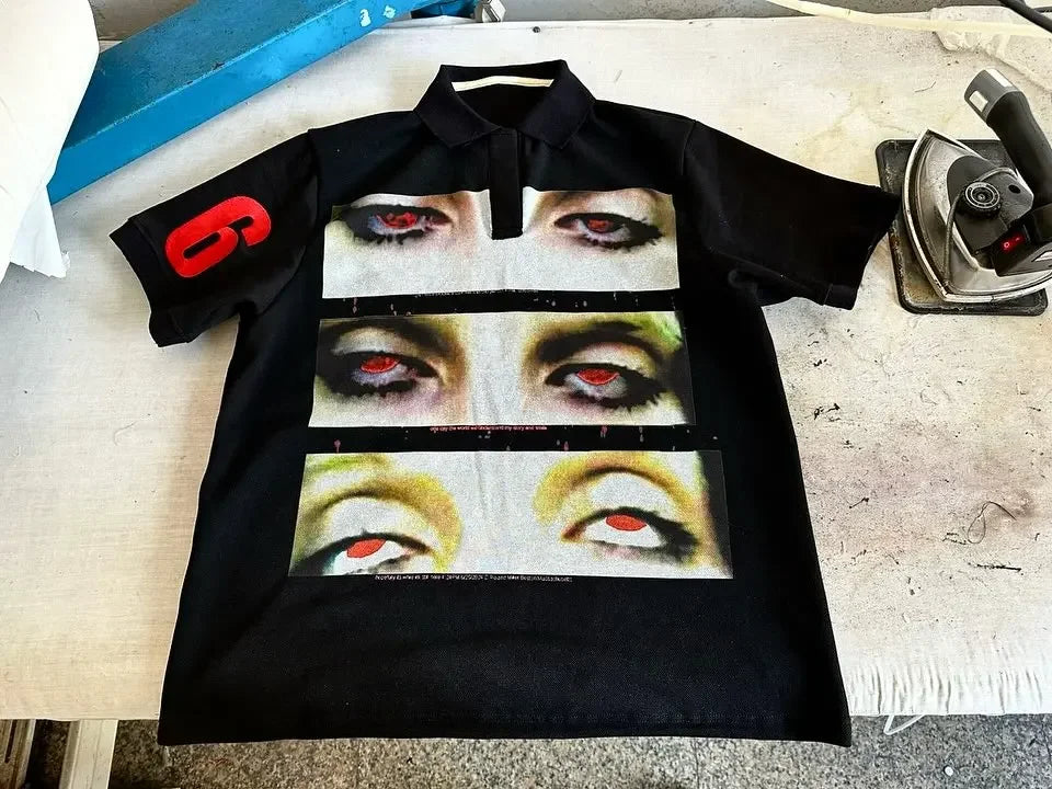 Black short-sleeved streetwear shirt y2k clothing with bold eye graphic strips and red patch for hip hop fashion