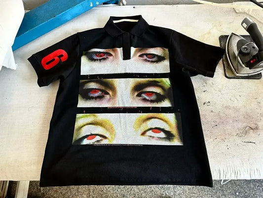 Black short-sleeved streetwear shirt y2k clothing with bold eye graphic strips and red patch for hip hop fashion