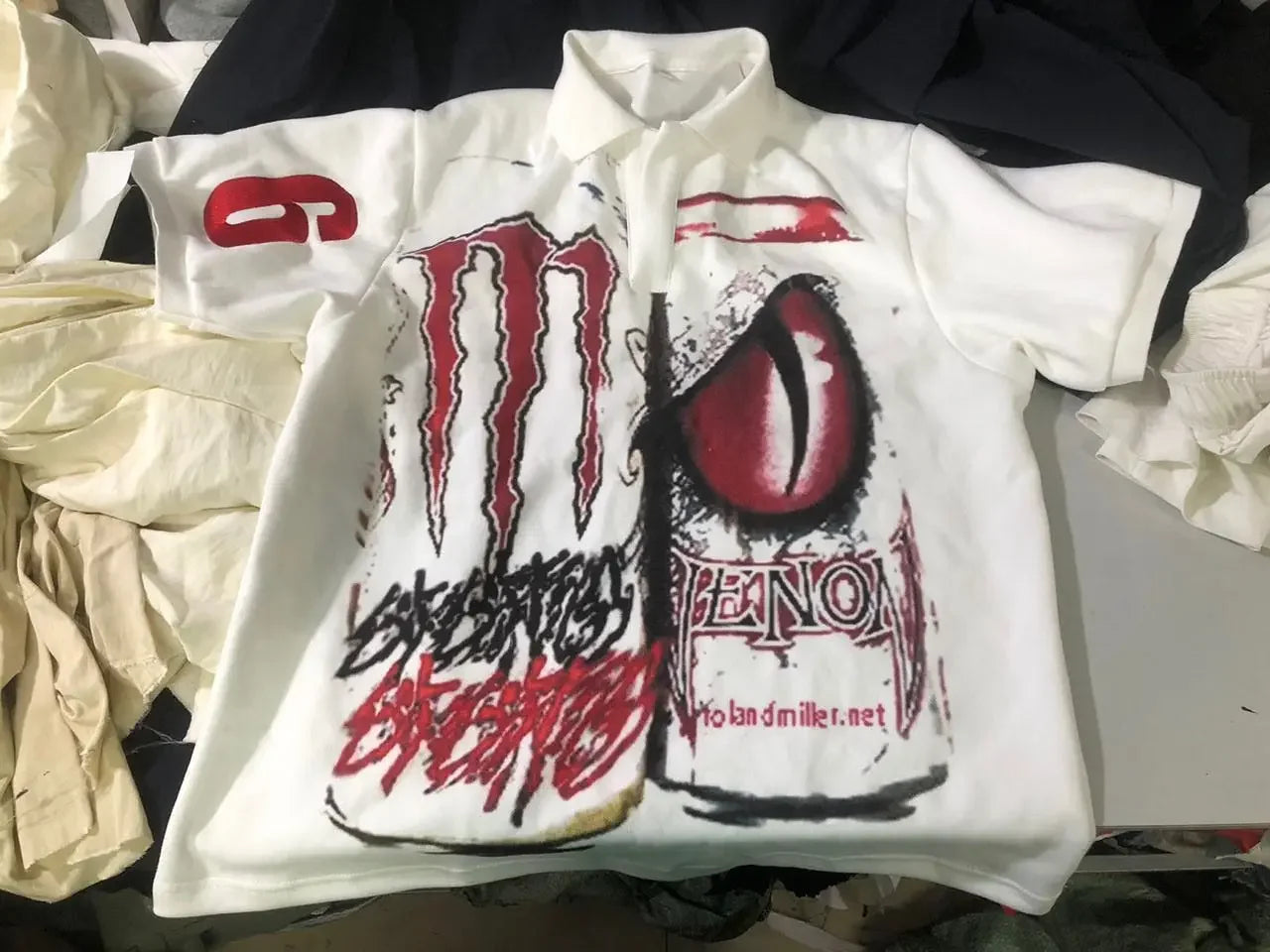 White short-sleeved polo streetwear shirt y2k with bold red black monster energy logo and venom graphic for hip hop fashion