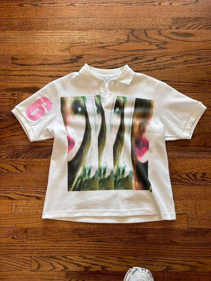White polo streetwear shirt y2k clothing with bold green and pink abstract face graphic and pink number 6 on sleeve