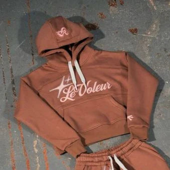 Rust-colored cropped hoodie with white drawstrings and le voleur logo embroidered in a piece set y2k clothes mens style