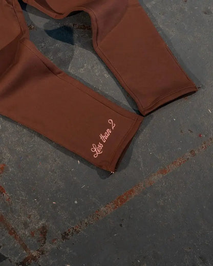 Brown leggings with less than 2 embroidered on cuff as part of streetwear sportswear two piece set y2k clothes mens hip hop