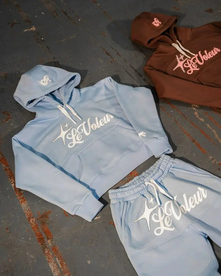 Light blue cropped hoodie and matching sweatpants set with white le voleur logo featuring star design y2k clothes mens piece set