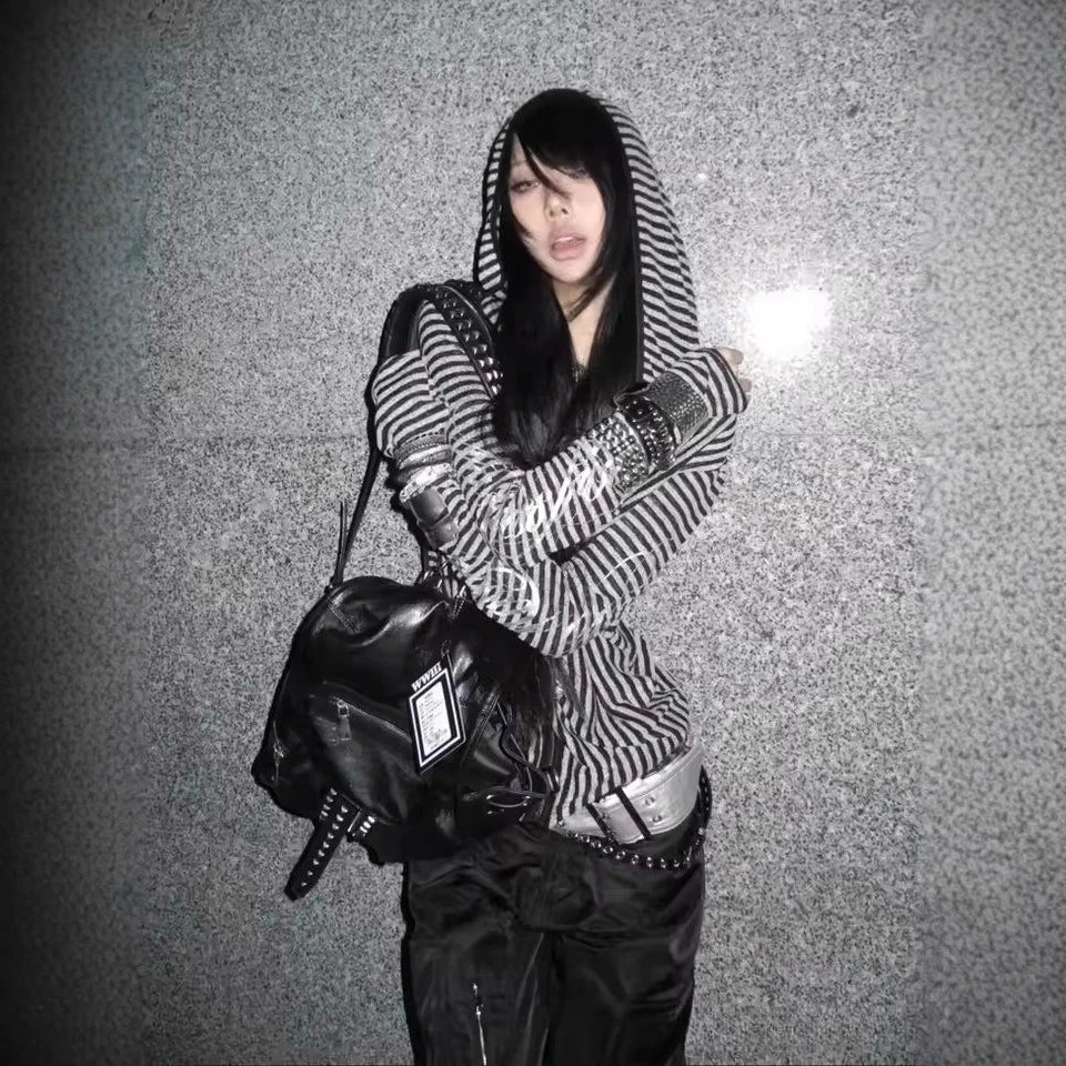 Black leather backpack with studded details and visible brand tag styled with hip hop y2k stripe harajuku hip hoodie grunge goth
