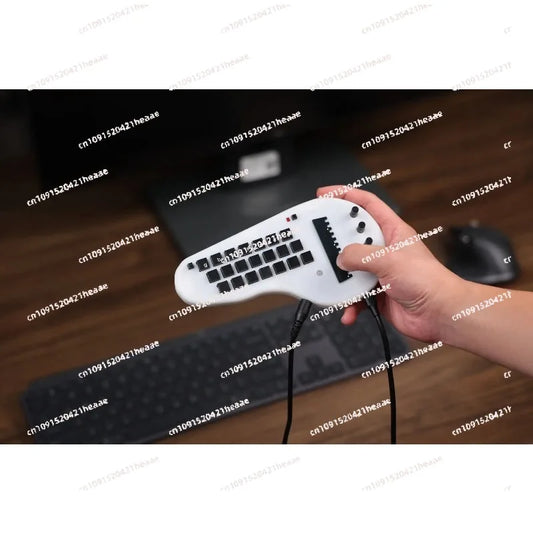White ergonomic gaming keyboard with black keys and 21 chord selector buttons for minichord synthesizer musicians