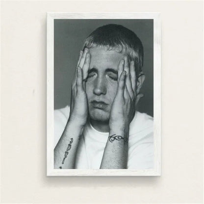 Black and white framed portrait of rapper with hands covering face and visible forearm tattoos in color change print poster