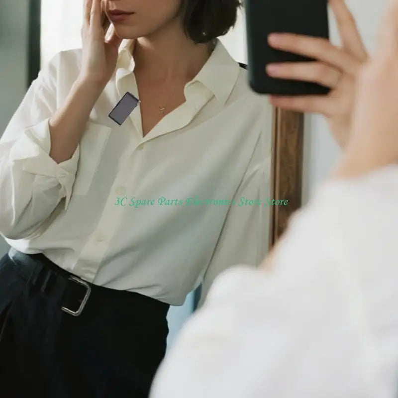 A sleek black smartphone held in hand with touchscreens control for sz intelligent wireless microphones and computer recording