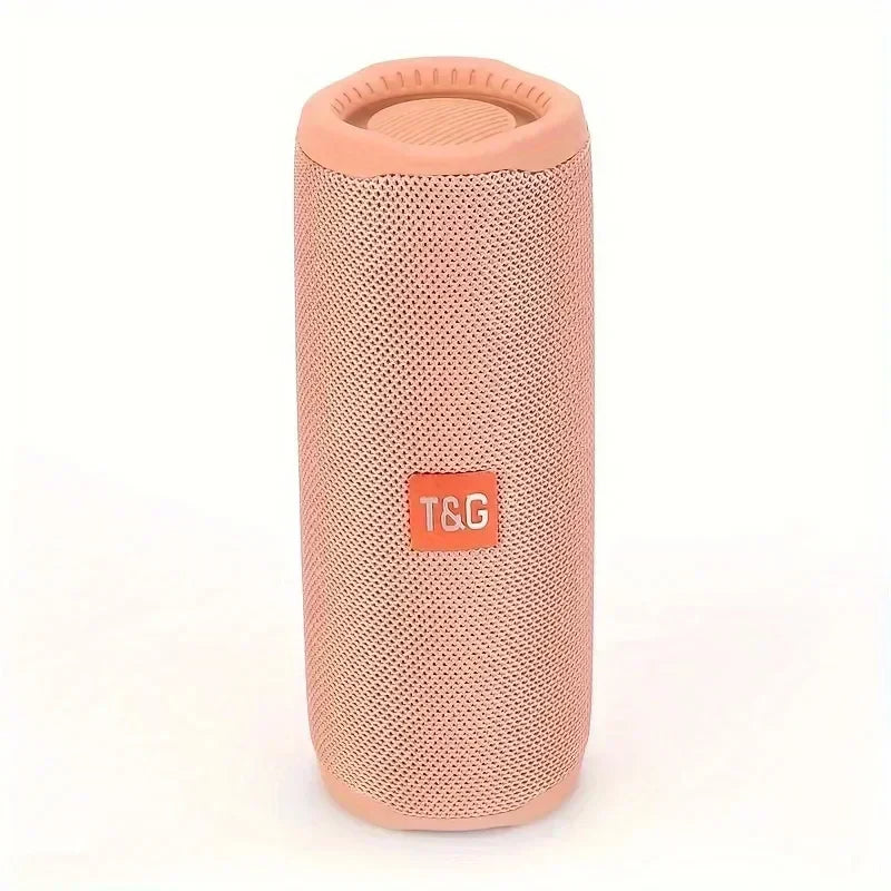 A pink cylindrical tg365 portable bluetooth speaker with mesh fabric and orange logo patch waterproof outdoor boombox