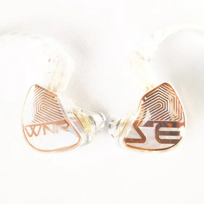 Clear teardrop-shaped tangzu wan er studio edition in ear monitors with rose gold geometric patterns and 10mm pet diaphragm