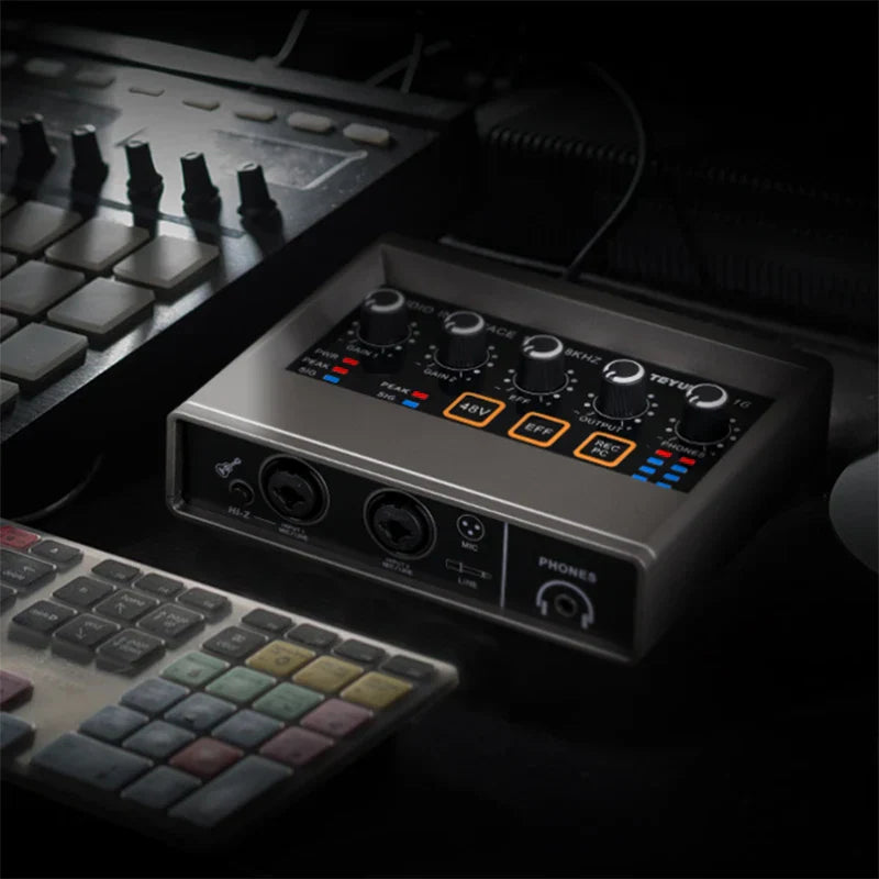 Silver metallic Teyun Q-16 professional audio sound interface with black knobs and orange LEDs for live broadcast studio monitor electric guitar recording