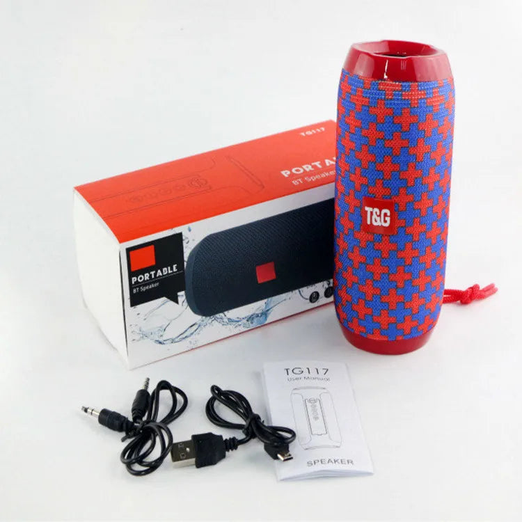 Red and blue patterned cylindrical bluetooth speaker with textured fabric exterior offering long battery life for outdoor use