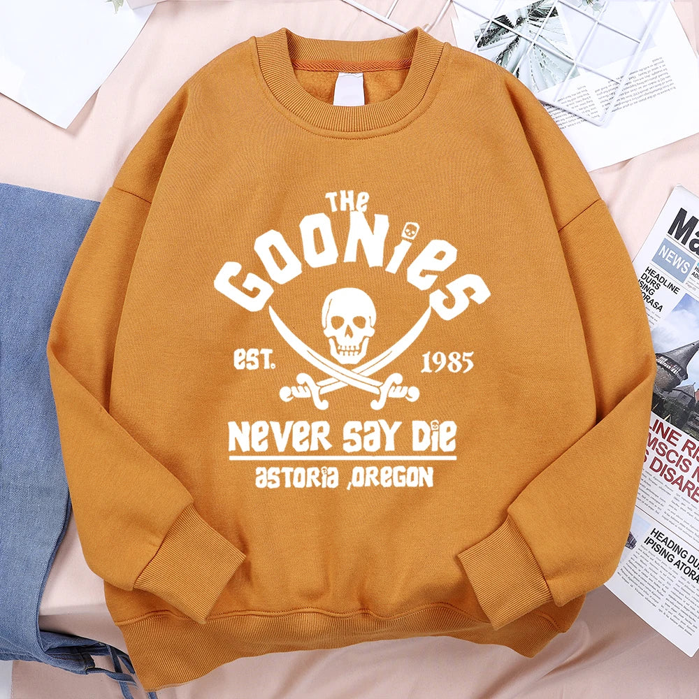 A mustard-yellow loose fleece sweatshirt with a white the goonies graphic for menswear fashion fitness