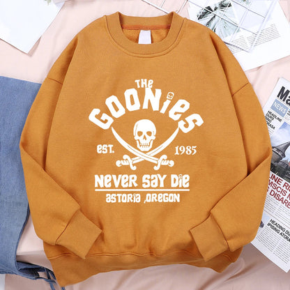 A mustard-yellow loose fleece sweatshirt with a white the goonies graphic for menswear fashion fitness