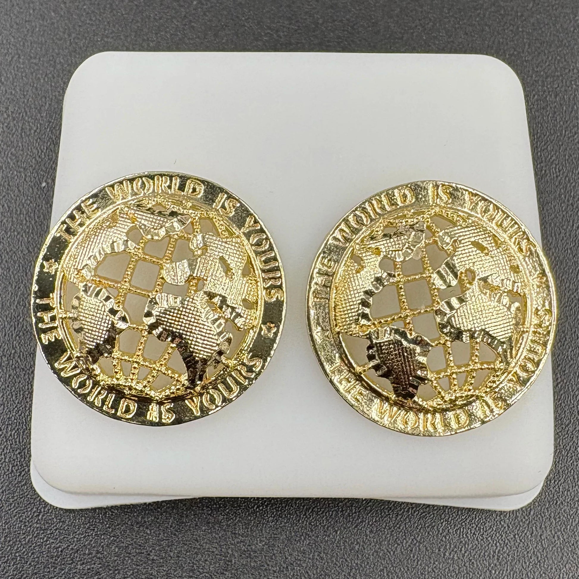 Gold-toned 14k gold plated stud earrings with globe design and the world is yours engraving hip hop style jewelry