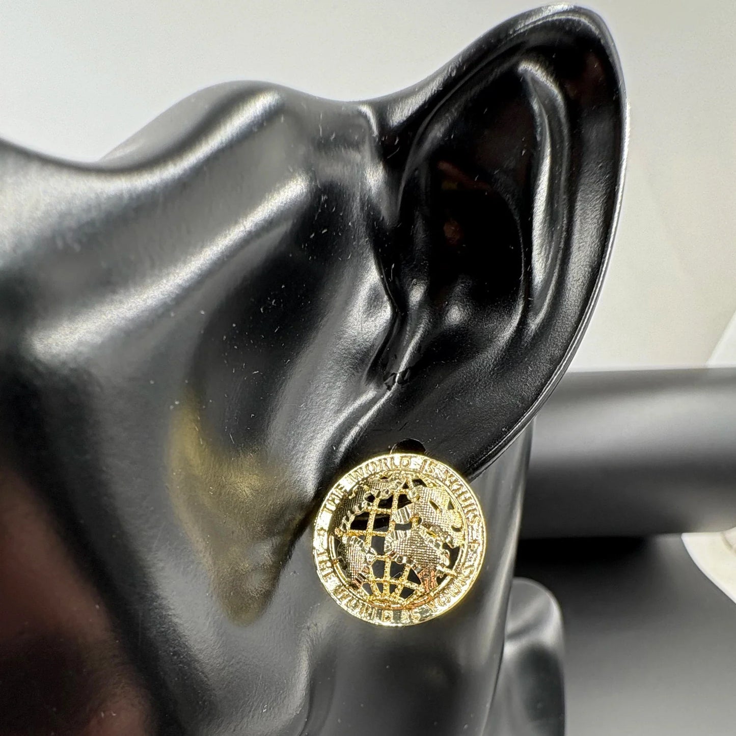 Gold-toned 14k gold plated stud earrings with intricate globe design and engraved text for hip hop style men and women