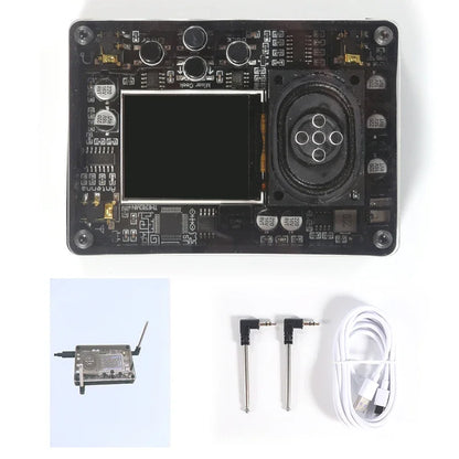 Black rectangular theremin musical instrument board with central screen, circular speaker, antenna, jacks, and usb cable as fun geek equipment