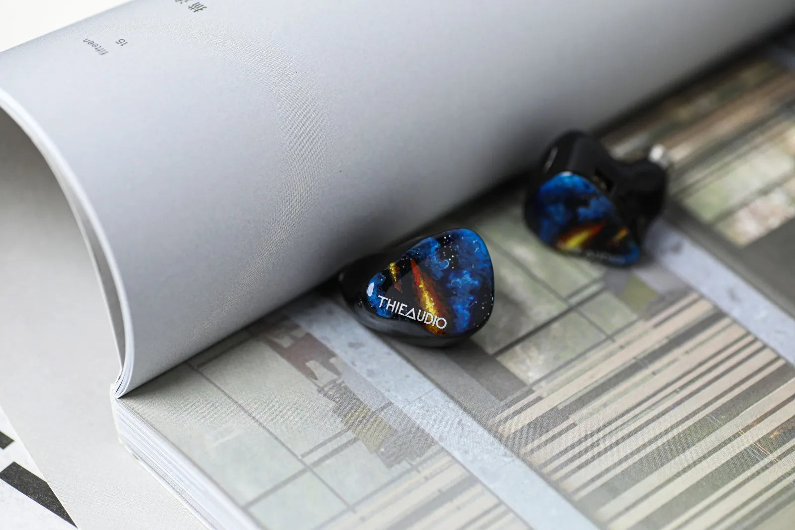 Blue and black inlayed thieaudio origin quadbrid iem hifi headphones with cosmic design for audiophiles musicians