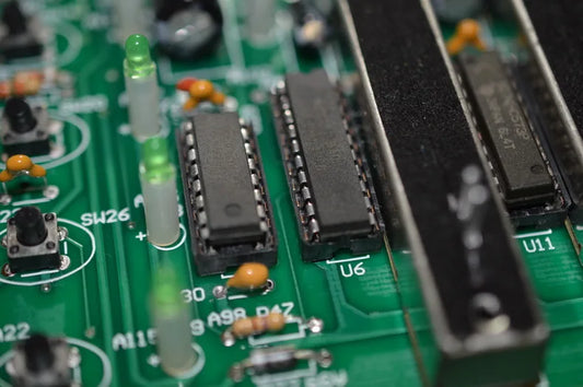 Black integrated circuit chips on green printed circuit board of top-selling new 192 dmx controller stage console dj controller equipment fast shipping