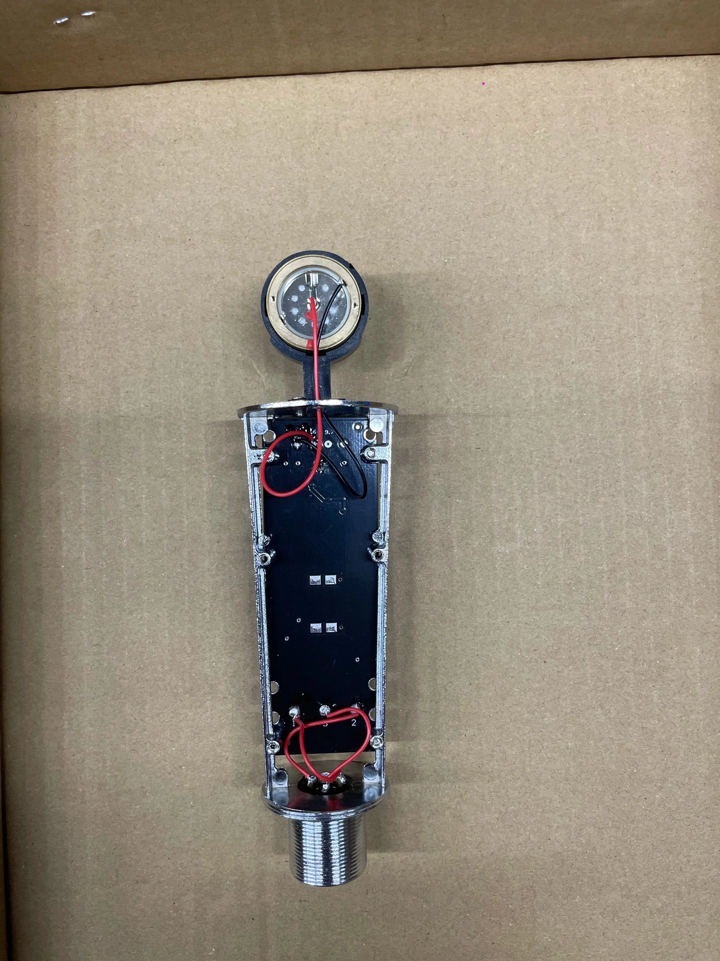 Silver metallic pressure gauge with threaded base on black circuit board for studio metal u87 professional cardioid studio use