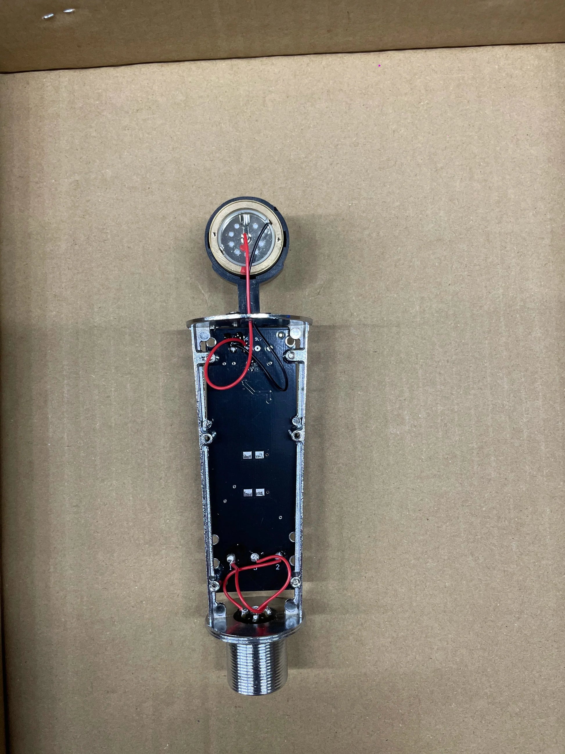 Silver metallic pressure gauge with threaded base on black circuit board for studio metal u87 professional cardioid studio use
