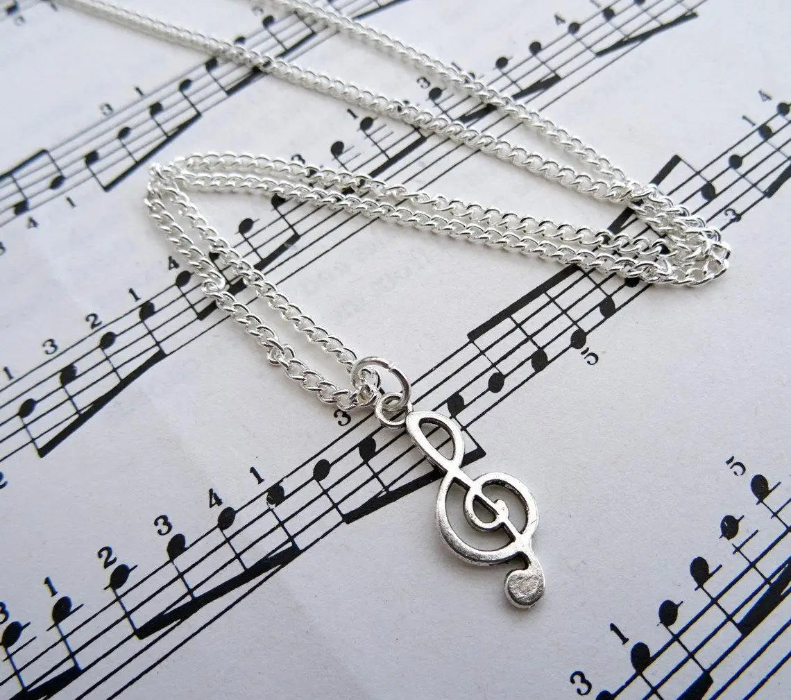Silver treble clef necklace with delicate chain featuring music note charm ideal for musician jewellery enthusiasts