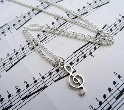 Silver treble clef necklace with delicate chain featuring music note charm ideal for musician jewellery enthusiasts