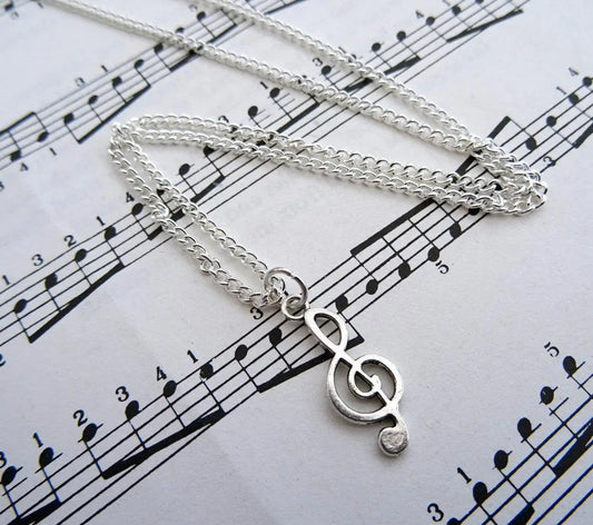 Silver treble clef necklace with delicate chain featuring music note charm ideal for musician jewellery enthusiasts