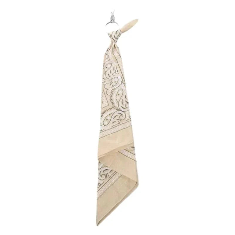 Beige bandana with black paisley pattern hanging from metal hook for trendy cashew print pants chain hip hop style accessory