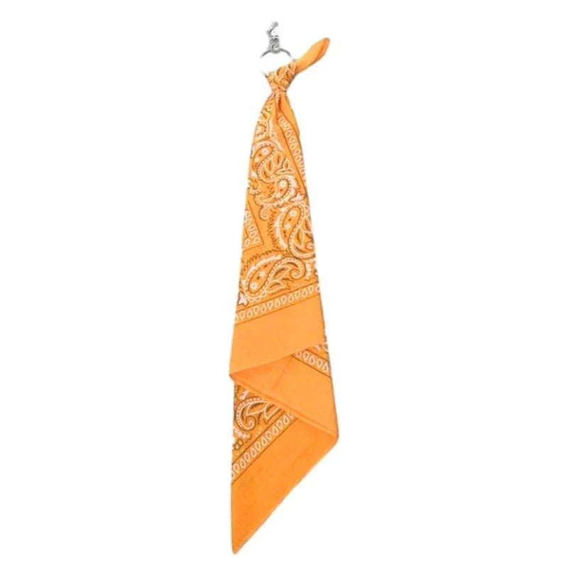Vibrant orange square scarf with trendy cashew print paisley design used as a hip hop style pants chain accessory