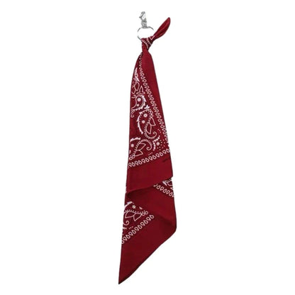 A crimson red paisley bandana with a metal ring used as a trendy cashew print hip hop style pants chain accessory