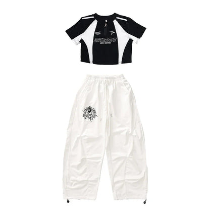 Black and white cropped top with bold graphic print and contrasting shoulder panels for teenage child hiphop dance rapper clothes