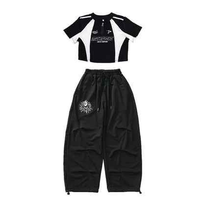 Black and white cropped top with bold graphic print and black drawstring pants with skull emblem for teenage child hiphop costume