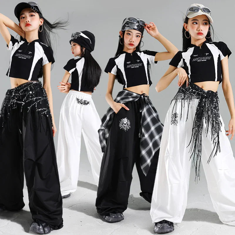 Black and white cropped hip hop costume tops with bold graphics paired with wide-leg pants for teenage child hiphop stage wear