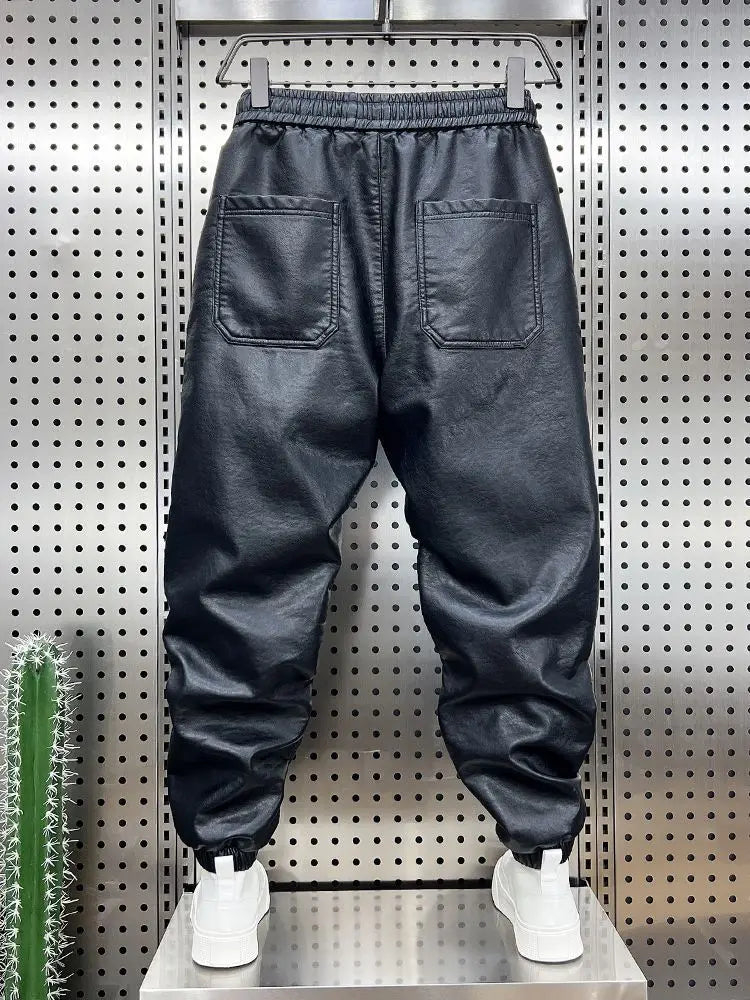 Back view of black faux leather trendy motorcycle leather jogger pants with elastic waistband and two back pockets