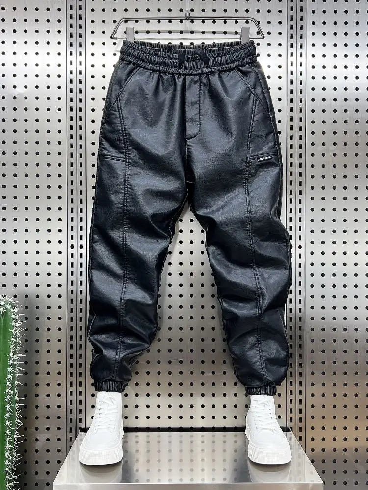 Black faux leather jogger pants with elastic waistband and drawstring featuring side pockets and tapered leg trendy motorcycle leather
